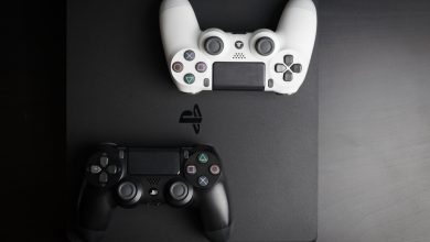 PS4 Slim with two controllers on top