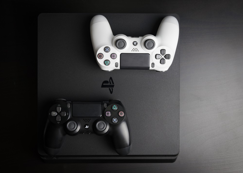 PS4 Slim with two controllers on top